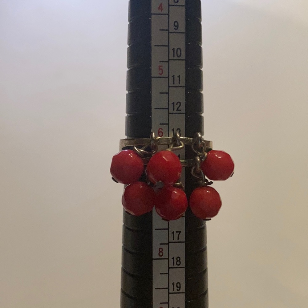 FREE WITH PURCHASE! Ring with red dangly beads on it.